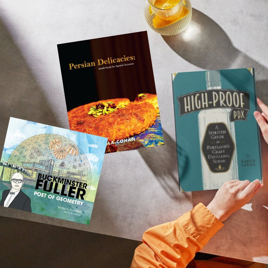 Image of three books on a table near a fancy beverage.